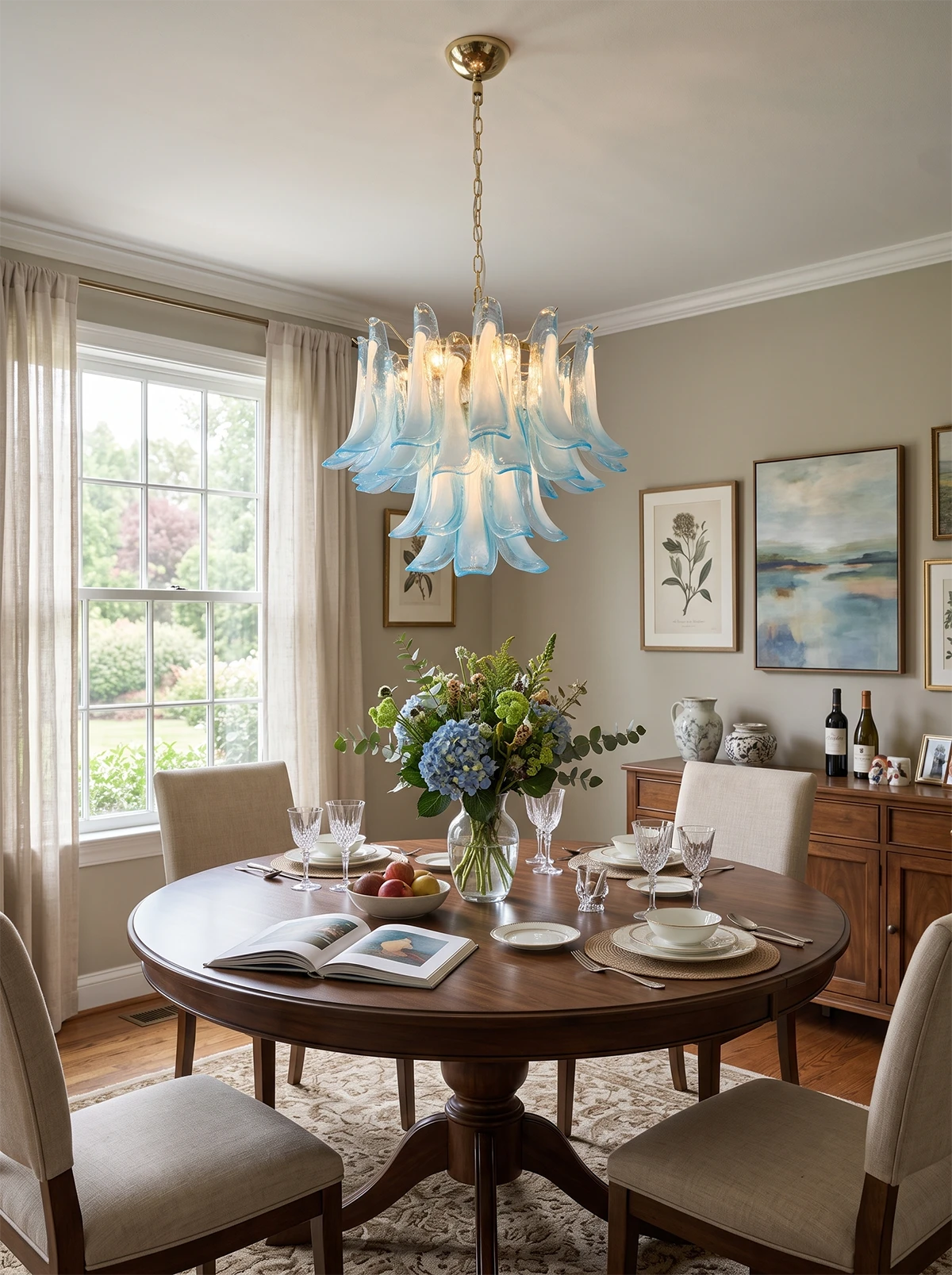 Lisette Curved Petal Glass Chandelier in blue and opal glass over a round dining table