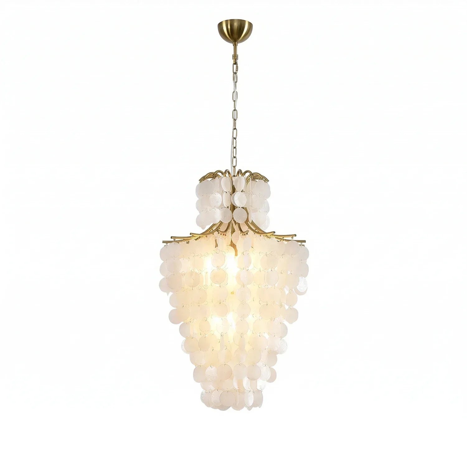 Teardrop-shaped natural capiz shell tiered chandelier glowing softly in a living room.